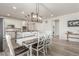 Bright dining area with wood floors, white trim and table open to kitchen with island at 12513 Shore Point St, Firestone, CO 80504