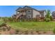 Large backyard with a wooden fence, garden, and view of the home's exterior at 12513 Shore Point St, Firestone, CO 80504