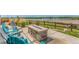 Outdoor stone fire pit surrounded by Adirondack chairs, with a scenic lake view at 12513 Shore Point St, Firestone, CO 80504