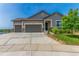 Charming home featuring a three-car garage and well-manicured lawn with a stone-accented facade at 12513 Shore Point St, Firestone, CO 80504