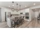 Modern kitchen featuring an island with counter seating, white cabinets, and stainless steel appliances at 12513 Shore Point St, Firestone, CO 80504