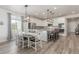 Modern kitchen with white cabinets, stainless steel appliances, and center island with seating at 12513 Shore Point St, Firestone, CO 80504