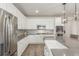 Bright kitchen with stainless steel appliances, white cabinets, and a farmhouse sink offers ample storage at 12513 Shore Point St, Firestone, CO 80504