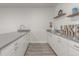 A stylish kitchenette with white cabinets and gray countertops at 12513 Shore Point St, Firestone, CO 80504