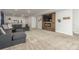 A cozy living room with a sectional sofa and a view of the kitchen at 12513 Shore Point St, Firestone, CO 80504