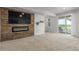 A spacious living room with a fireplace and a door leading to the outside at 12513 Shore Point St, Firestone, CO 80504