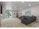 A spacious living room with a sectional sofa and a door leading to the outside at 12513 Shore Point St, Firestone, CO 80504
