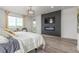Bright main bedroom with a modern fireplace, television, and large window for a relaxing, cozy atmosphere at 12513 Shore Point St, Firestone, CO 80504