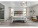 Comfortable main bedroom with a rustic headboard, neutral tones, and natural light creates a peaceful ambiance at 12513 Shore Point St, Firestone, CO 80504