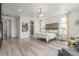 Spacious main bedroom features neutral decor, fireplace, and a rustic headboard for a cozy retreat at 12513 Shore Point St, Firestone, CO 80504