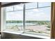 A bright, large window overlooks the lake, offering a scenic view and natural light at 12513 Shore Point St, Firestone, CO 80504