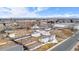 An aerial perspective shows a white home in a neighborhood close to a commercial district and open land at 2650 W Asbury Ave, Denver, CO 80219