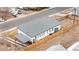 An elevated view showcases a gray roof and fenced yard of a modern, white home near a quiet neighborhood street at 2650 W Asbury Ave, Denver, CO 80219