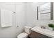 Bathroom features a modern sink, toilet, mirror, and towel rack at 2650 W Asbury Ave, Denver, CO 80219
