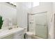 This bathroom features a sleek vanity, toilet, and a glass-enclosed shower, complemented by a white and gray color scheme at 2650 W Asbury Ave, Denver, CO 80219