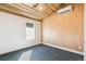 Bright bedroom features wood ceiling, window, and air conditioning unit at 2650 W Asbury Ave, Denver, CO 80219