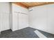 Bright bedroom features wood ceiling, closet, and air conditioning unit at 2650 W Asbury Ave, Denver, CO 80219