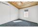 Empty bedroom with carpet, a window, and a wooden ceiling at 2650 W Asbury Ave, Denver, CO 80219