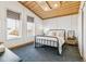 Comfortable bedroom featuring a metal frame bed, plush bedding, and natural light from large windows at 2650 W Asbury Ave, Denver, CO 80219