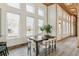 Inviting dining room with a modern table set, surrounded by bright windows and natural light at 2650 W Asbury Ave, Denver, CO 80219