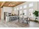 Bright dining area features large windows, modern furnishings, and an open layout to the kitchen at 2650 W Asbury Ave, Denver, CO 80219