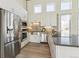 Modern kitchen features stainless steel appliances, light wood cabinets, and a sleek countertop at 2650 W Asbury Ave, Denver, CO 80219