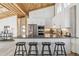 Contemporary kitchen boasts a breakfast bar with seating, stainless appliances, and unique wood ceiling at 2650 W Asbury Ave, Denver, CO 80219
