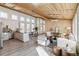 Bright and open living room and kitchen with wood plank ceiling and a modern design at 2650 W Asbury Ave, Denver, CO 80219