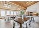 Bright open-concept living room and kitchen with wood plank ceiling and modern design at 2650 W Asbury Ave, Denver, CO 80219