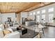 Spacious living area with modern design, bright white walls, and wood plank ceiling at 2650 W Asbury Ave, Denver, CO 80219