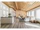 Bright and open living room and kitchen with wood plank ceiling and a modern design at 2650 W Asbury Ave, Denver, CO 80219