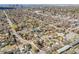 Expansive aerial view of a neighborhood with tree-lined streets and city skyline backdrop at 5611 E 13Th Ave, Denver, CO 80220