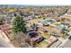 Aerial view of the property showcasing the surrounding neighborhood, trees, and cityscape at 5611 E 13Th Ave, Denver, CO 80220