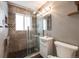 Modern bathroom with tiled walls, glass-enclosed shower, and a sleek vanity at 5611 E 13Th Ave, Denver, CO 80220