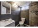 Modern bathroom features a walk-in shower with accent tile, plus a sink and toilet at 5611 E 13Th Ave, Denver, CO 80220