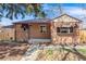 Charming brick home featuring a well-manicured lawn and cozy, covered front porch at 5611 E 13Th Ave, Denver, CO 80220