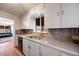 Charming kitchen featuring white cabinets, granite countertops, and stainless steel sink, a functional and stylish space at 5611 E 13Th Ave, Denver, CO 80220