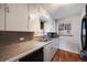This is a traditionally styled kitchen with light cabinets, stainless sink, and plenty of natural light at 5611 E 13Th Ave, Denver, CO 80220
