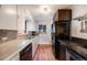 Modern kitchen with stainless steel appliances, white cabinets, and hardwood floors, perfect for culinary enthusiasts at 5611 E 13Th Ave, Denver, CO 80220