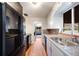 Functional kitchen boasting updated appliances, white cabinetry, and hardwood floors, offering a practical and inviting space at 5611 E 13Th Ave, Denver, CO 80220