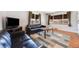 Well-lit living room with large windows, hardwood floors, and cozy seating, creating an inviting space for gatherings at 5611 E 13Th Ave, Denver, CO 80220