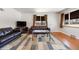 Spacious living room showcasing hardwood floors, ample natural light, and modern furniture, ideal for comfortable living at 5611 E 13Th Ave, Denver, CO 80220