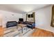 Bright living room featuring hardwood floors, a large window, and comfortable seating arrangement perfect for relaxation at 5611 E 13Th Ave, Denver, CO 80220