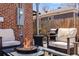 Outdoor seating area with a fire pit and grill, perfect for entertaining in the backyard at 5611 E 13Th Ave, Denver, CO 80220