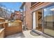 Private back patio offers a glimpse of the wooden stairway and hardwood floors within the home at 8040 Holland Ct # C, Arvada, CO 80005