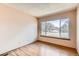 Cozy bedroom with a large window allowing for ample natural light and wood floors at 8040 Holland Ct # C, Arvada, CO 80005