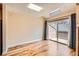 Bright, open room with hardwood floors, a sliding glass door to a deck, and natural light streaming in at 8040 Holland Ct # C, Arvada, CO 80005