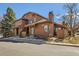 Charming brown townhouse with well-maintained landscaping, featuring a porch and a black railing at 8040 Holland Ct # C, Arvada, CO 80005