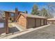 Detached garage with three bays and brown siding, offering ample parking and storage at 8040 Holland Ct # C, Arvada, CO 80005