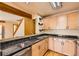 Well-lit kitchen features granite countertops, light wood cabinets, and a seamless view into the living area at 8040 Holland Ct # C, Arvada, CO 80005